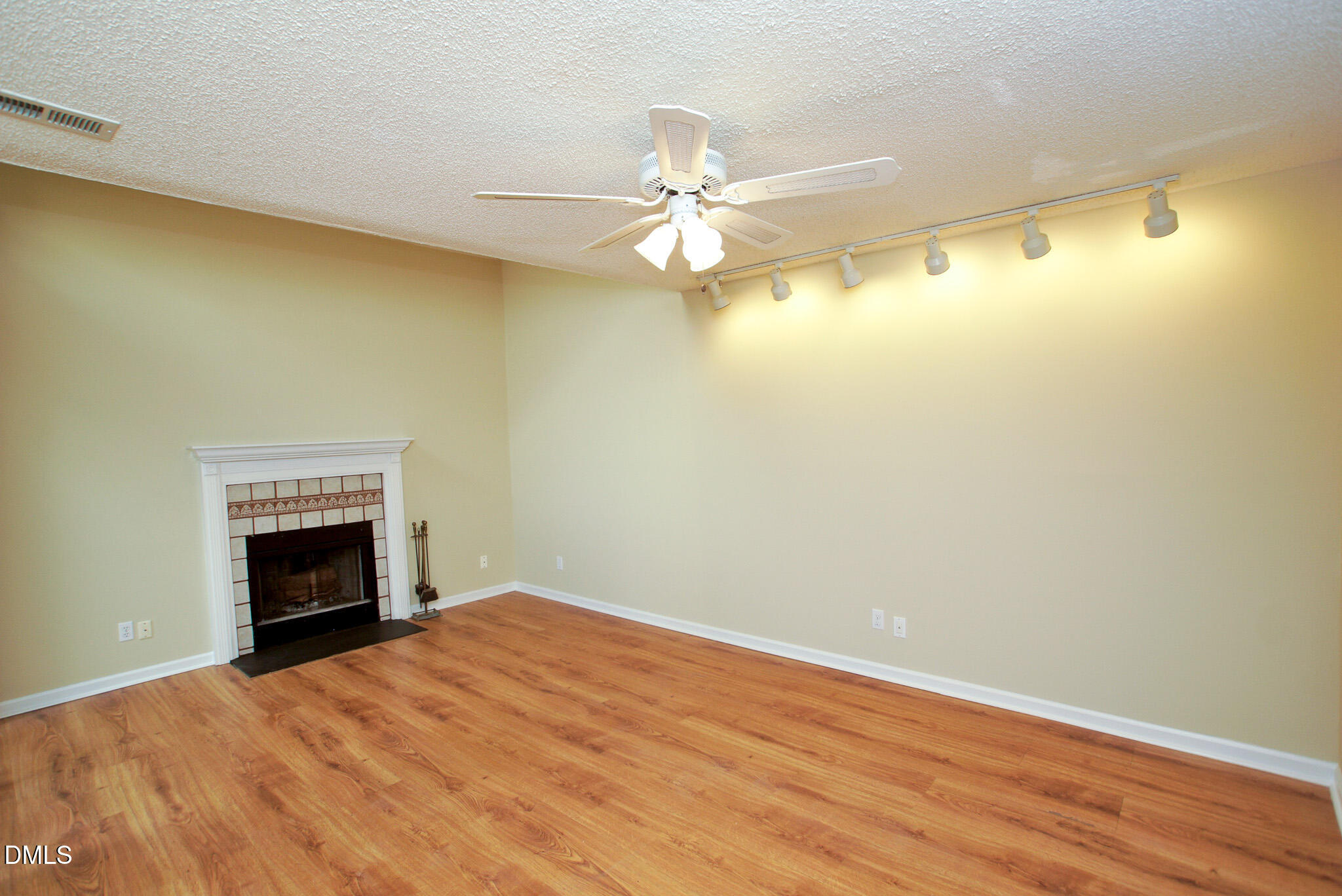 4101 Five Oaks Drive, Unit 10 Durham, NC 27707 - Photo 13 of 29 an empty room with a fireplace and fan