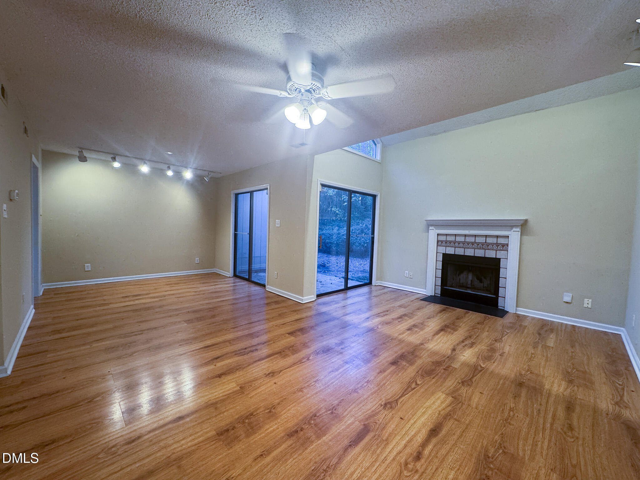 4101 Five Oaks Drive, Unit 10 Durham, NC 27707 - Photo 15 of 29 a view of an empty room with wooden floor and a fireplace