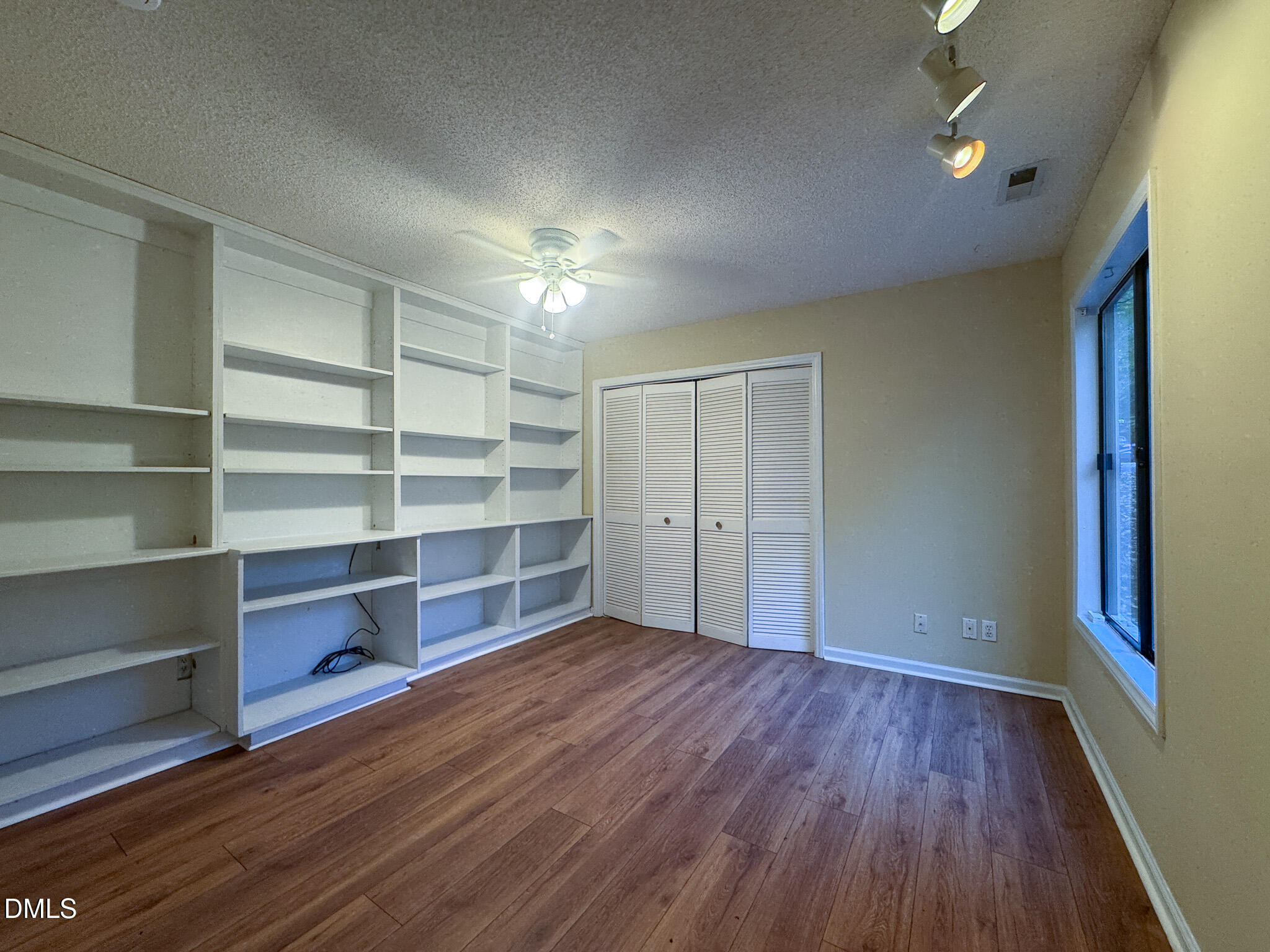 4101 Five Oaks Drive, Unit 10 Durham, NC 27707 - Photo 16 of 29 a view of an empty room with a window and wooden floor