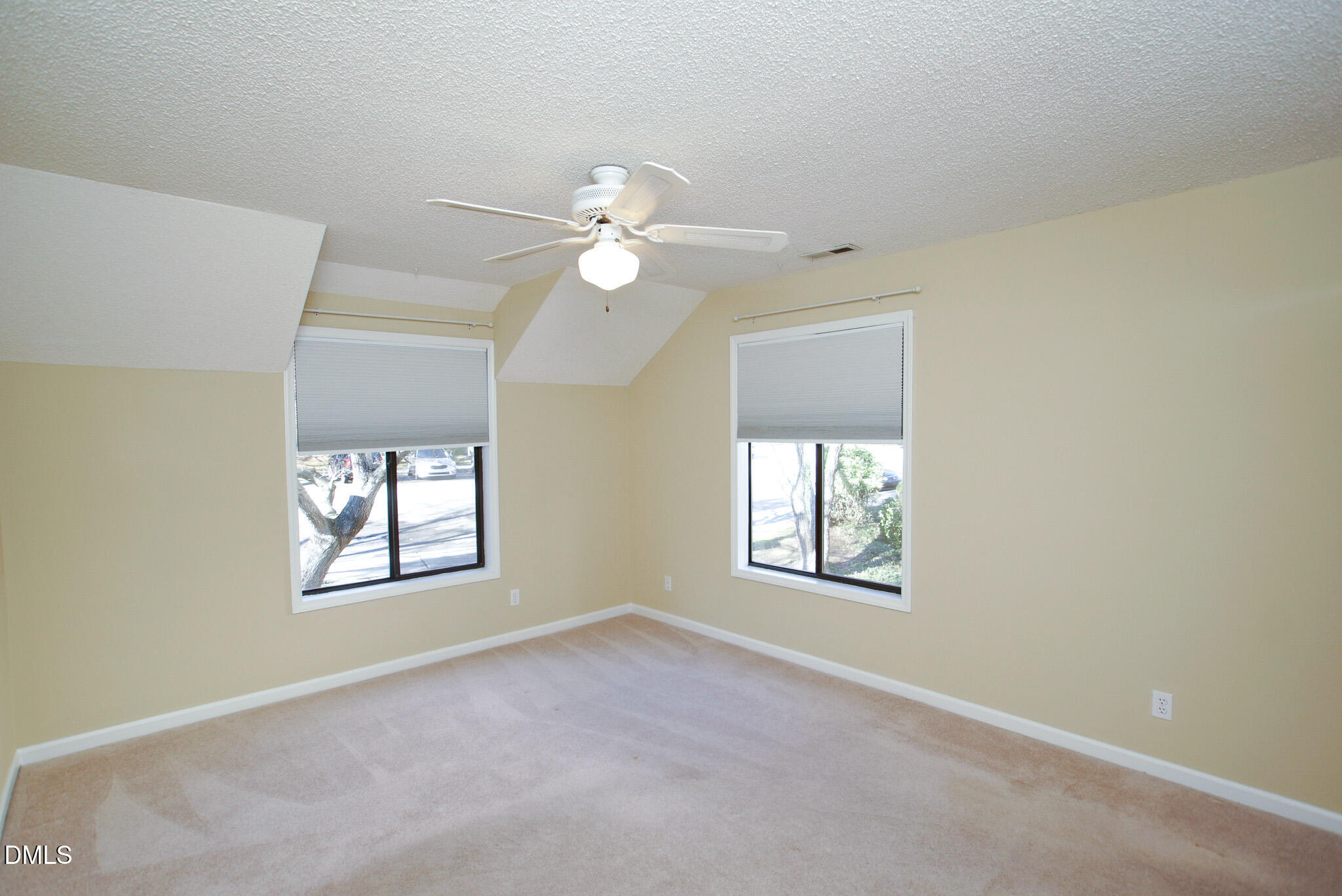 4101 Five Oaks Drive, Unit 10 Durham, NC 27707 - Photo 22 of 29 an empty room with windows and ceiling fan