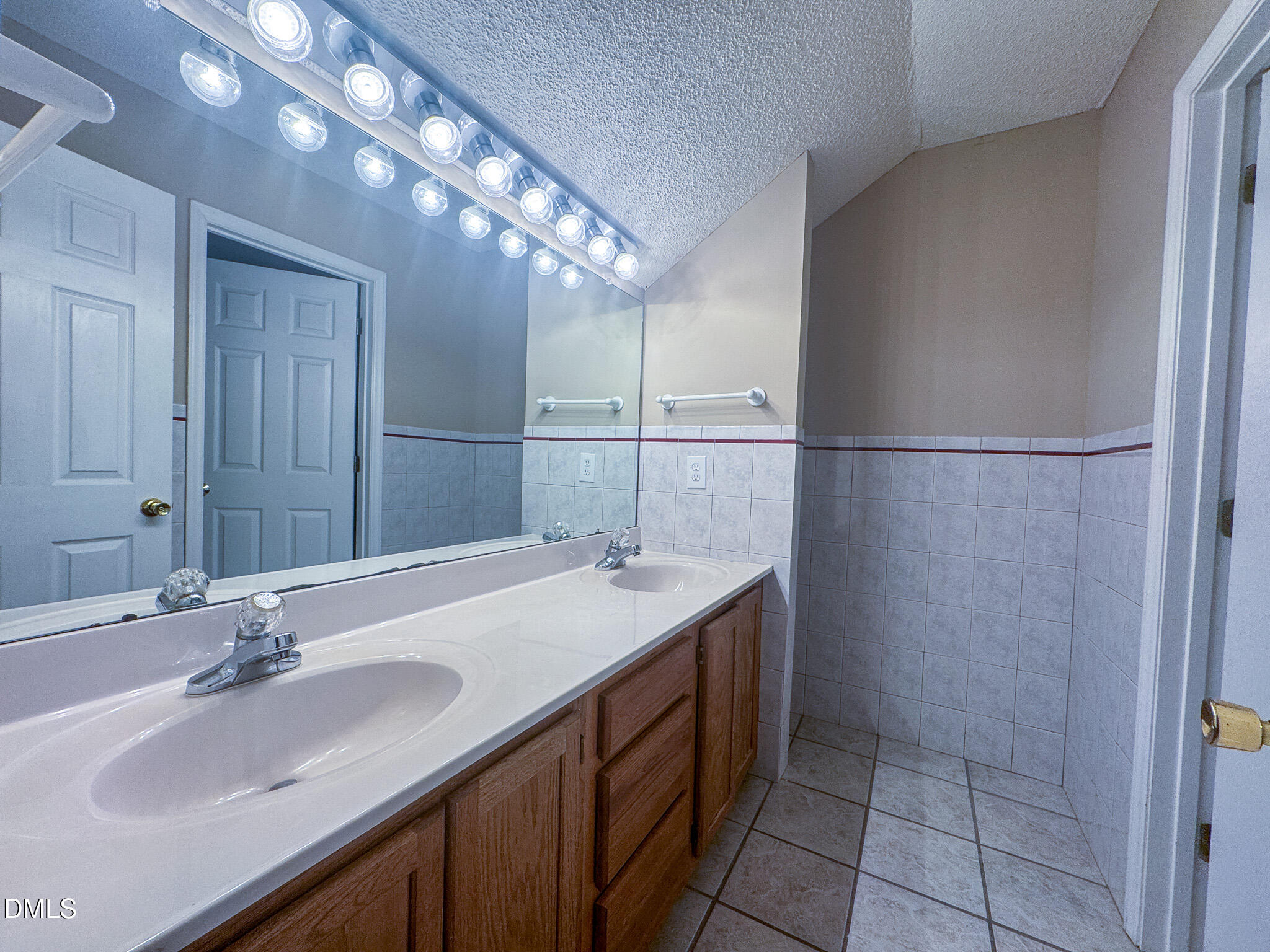 4101 Five Oaks Drive, Unit 10 Durham, NC 27707 - Photo 25 of 29 a bathroom with a sink and a mirror