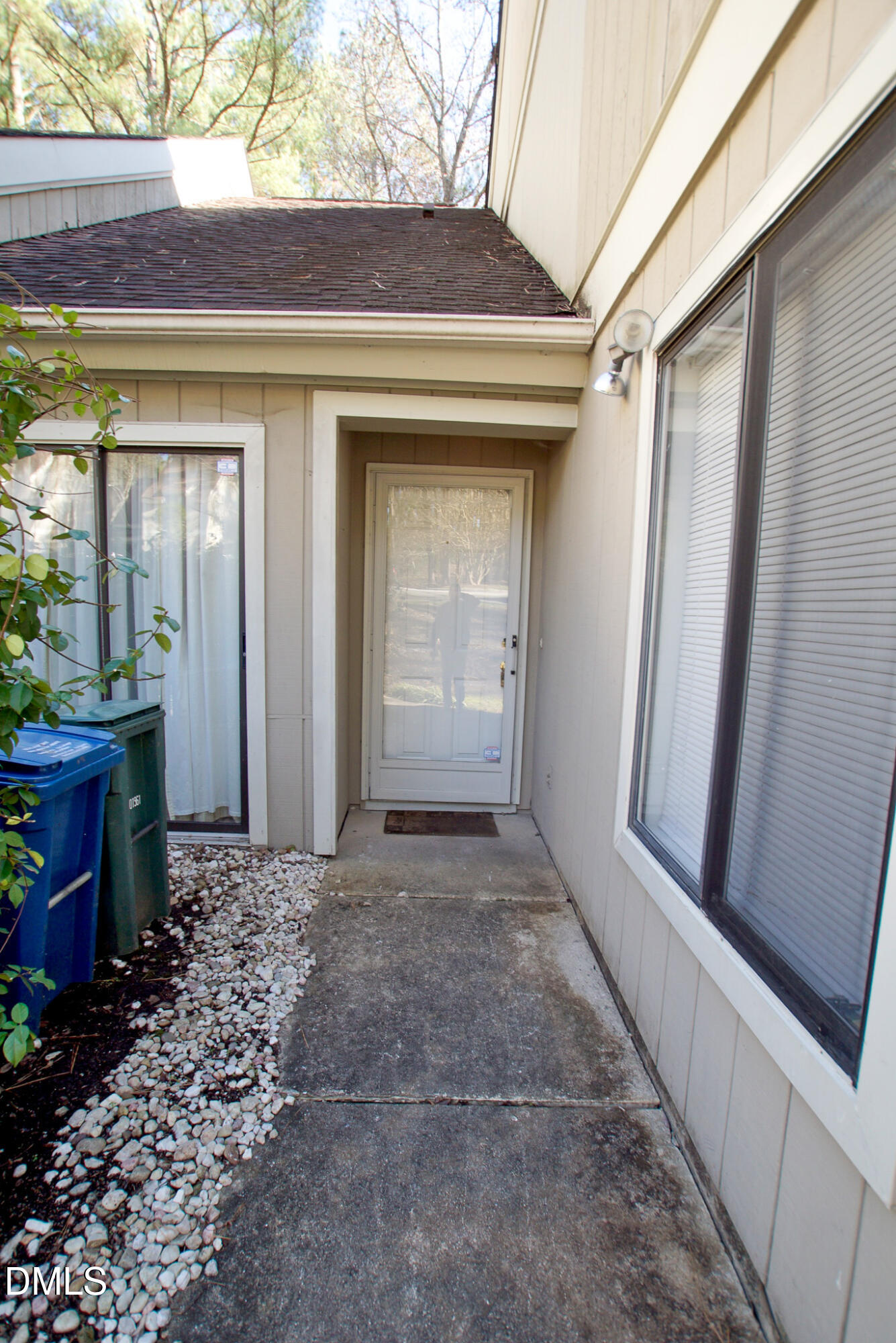 4101 Five Oaks Drive, Unit 10 Durham, NC 27707 - Photo 3 of 29 a view of a house with a door and wooden bench
