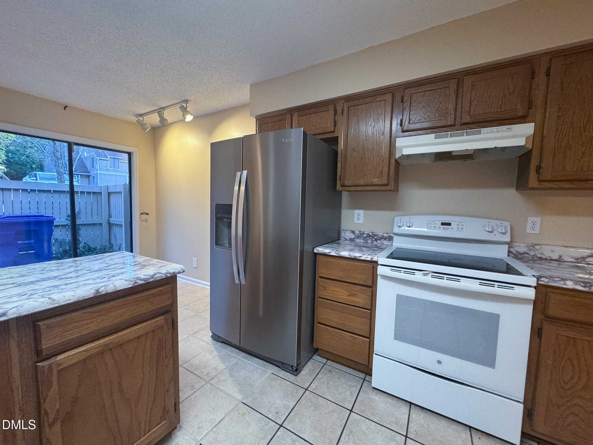 4101 Five Oaks Drive, Unit 10 Durham, NC 27707 - Photo 8 of 29 a kitchen with granite countertop a stove oven and refrigerator
