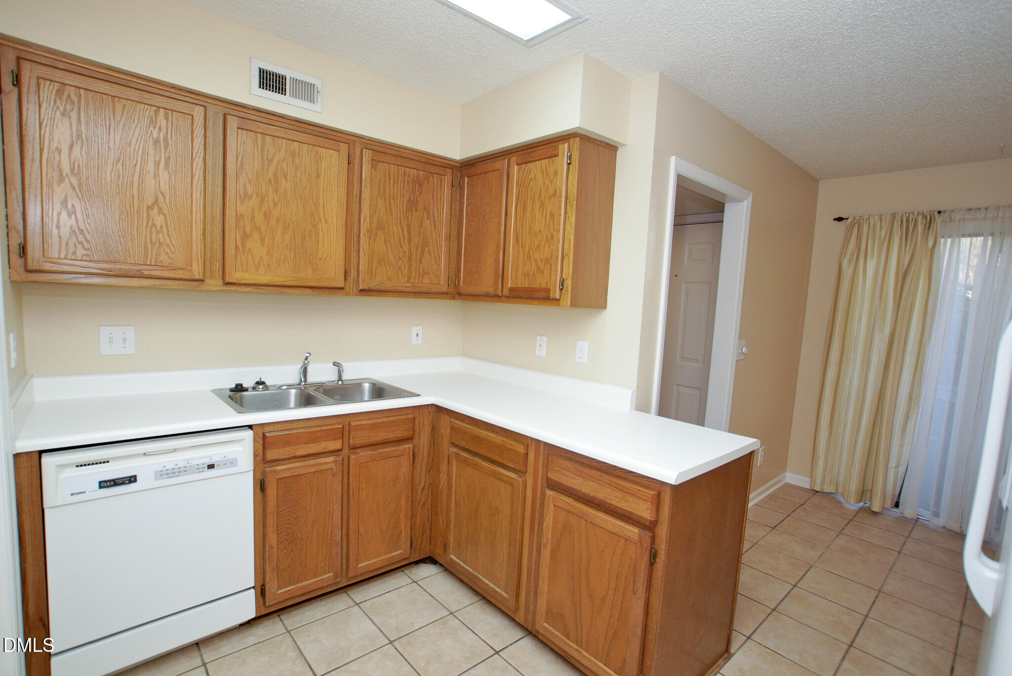 4101 Five Oaks Drive, Unit 10 Durham, NC 27707 - Photo 10 of 29 a kitchen with stainless steel appliances granite countertop a sink stove and cabinets