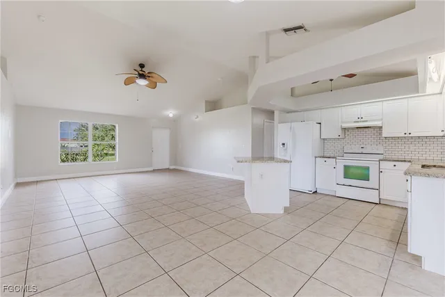 a view of a kitchen with furniture and a kitchen