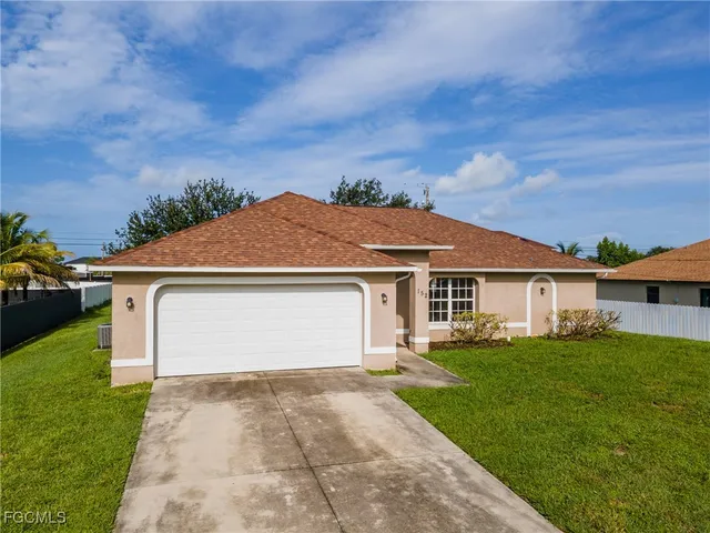 a front view of house with yard and green space