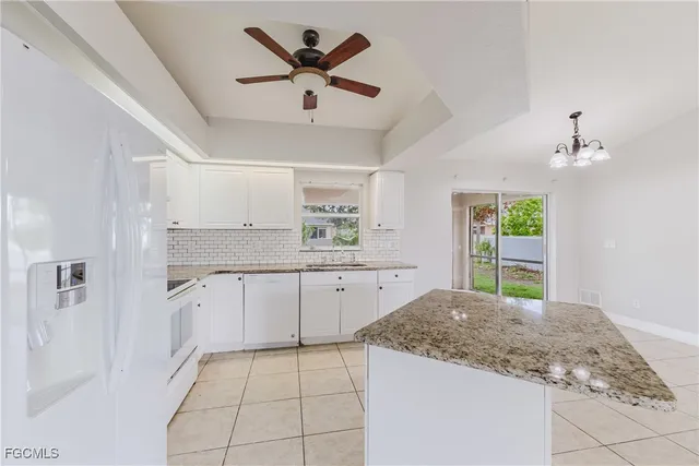 a kitchen with a stove a sink and a refrigerator