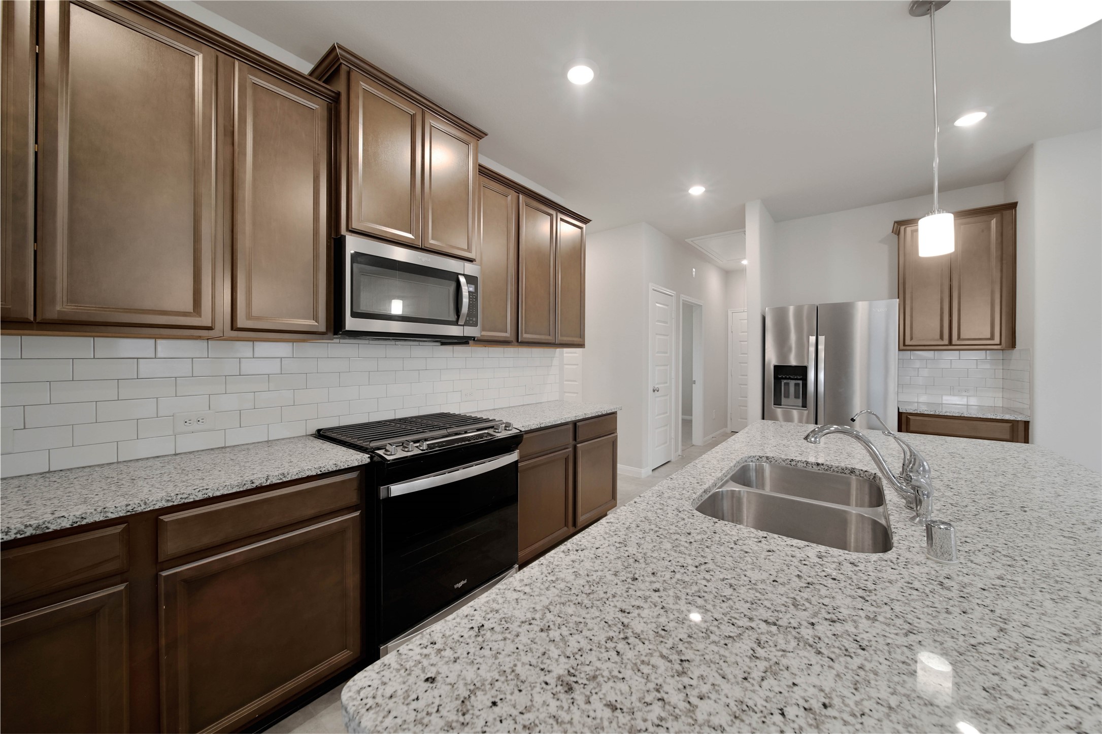 7080 Silverleaf Oak Street Conroe, TX 77304 - Photo 5 of 35 Whirlpool appliances that include a multi-function gas range with air frying capabilities and a side-by-side refrigerator will stay with the home.