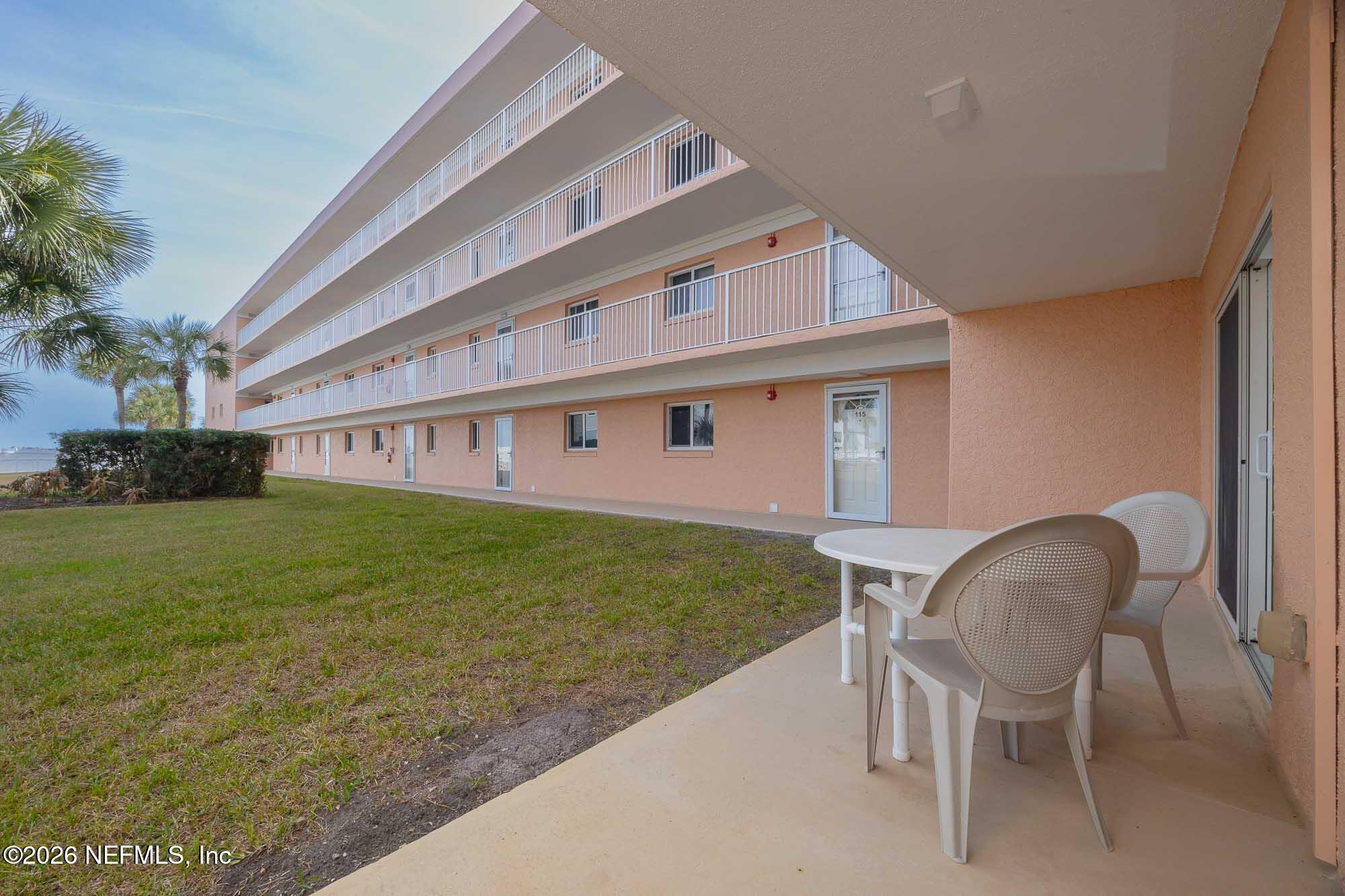 4 Ocean Trace Road, Unit 122 St. Augustine Beach, FL 32080 - Photo 21 of 48 a view of a house with backyard and sitting area