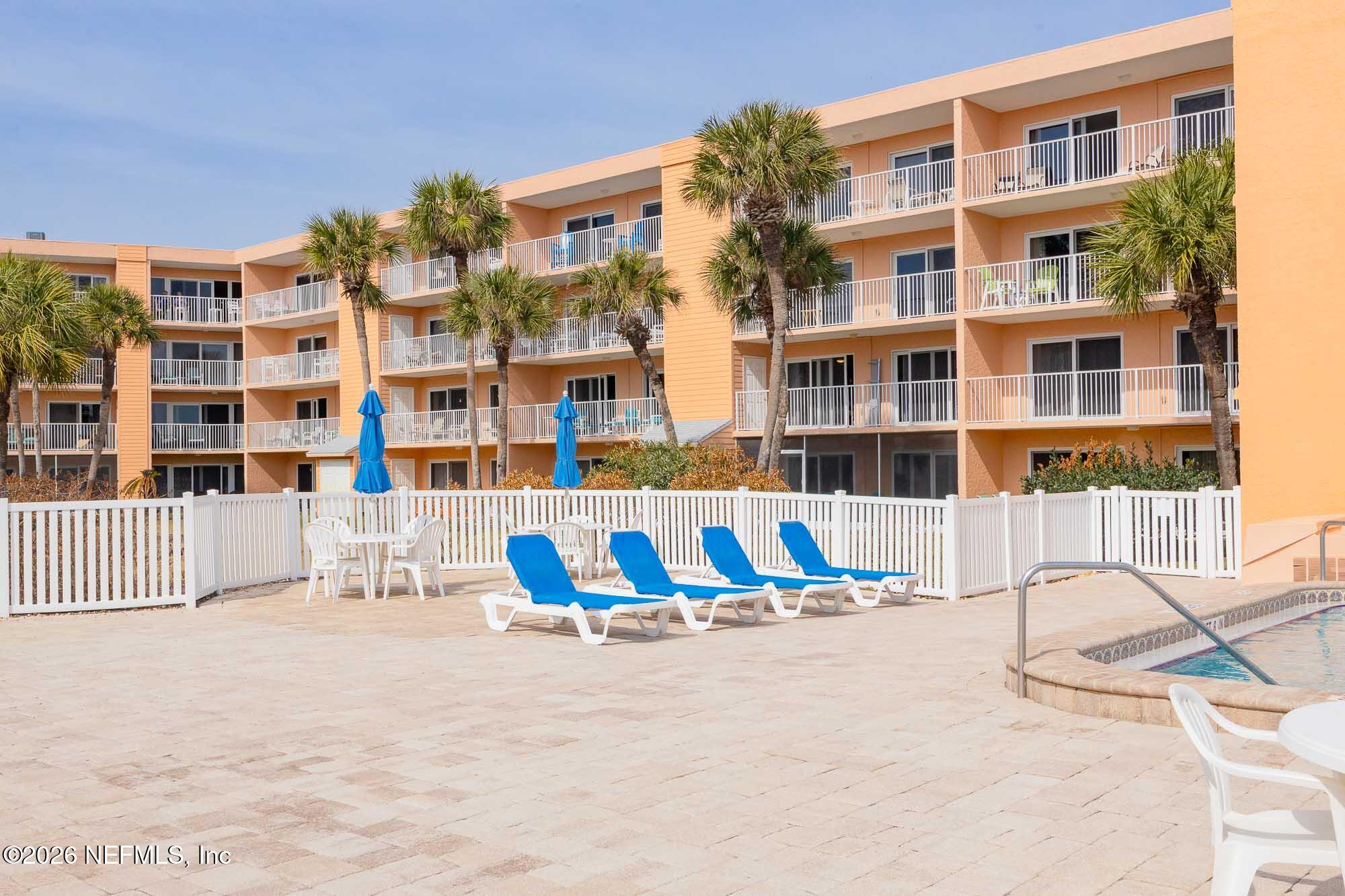 4 Ocean Trace Road, Unit 122 St. Augustine Beach, FL 32080 - Photo 29 of 48 a view of tall building with large windows and plants