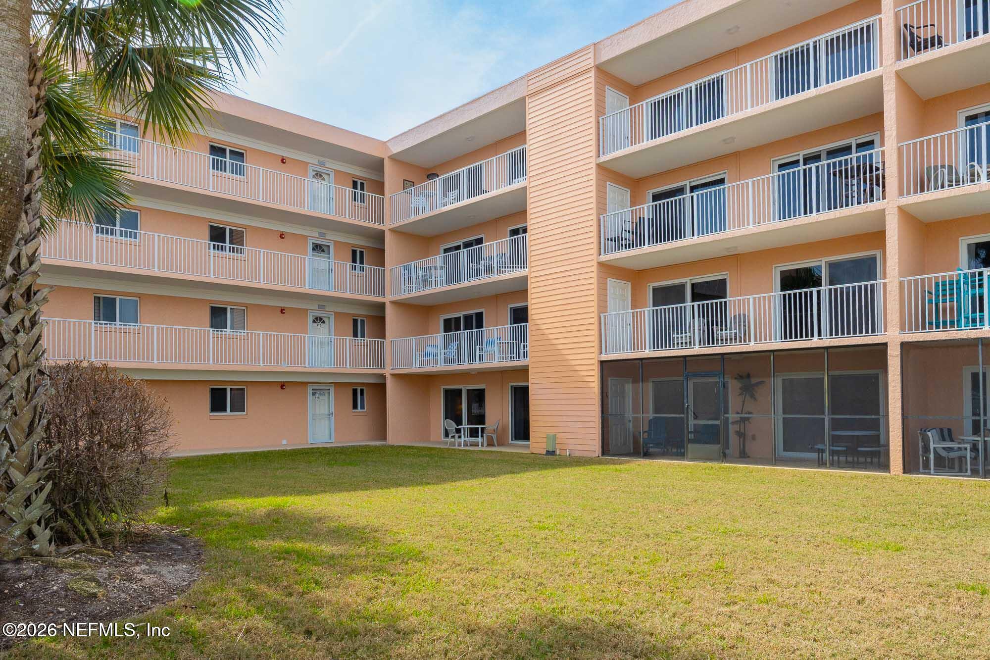 4 Ocean Trace Road, Unit 122 St. Augustine Beach, FL 32080 - Photo 31 of 48 a front view of building with outdoor space and swimming pool
