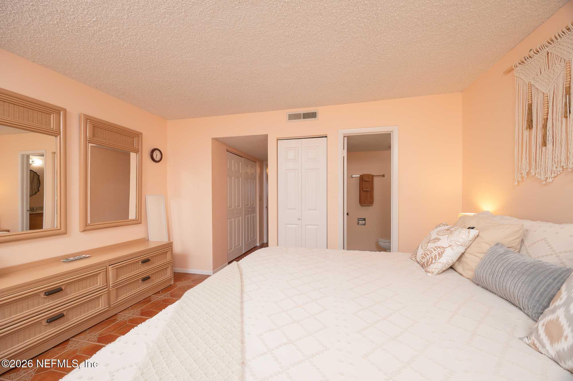 4 Ocean Trace Road, Unit 122 St. Augustine Beach, FL 32080 - Photo 37 of 48 a bedroom with a large bed and a window