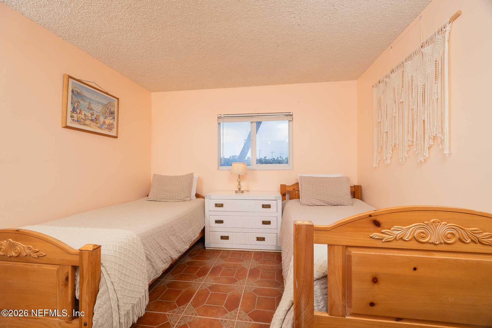 4 Ocean Trace Road, Unit 122 St. Augustine Beach, FL 32080 - Photo 42 of 48 a bedroom with a bed and a cabinets