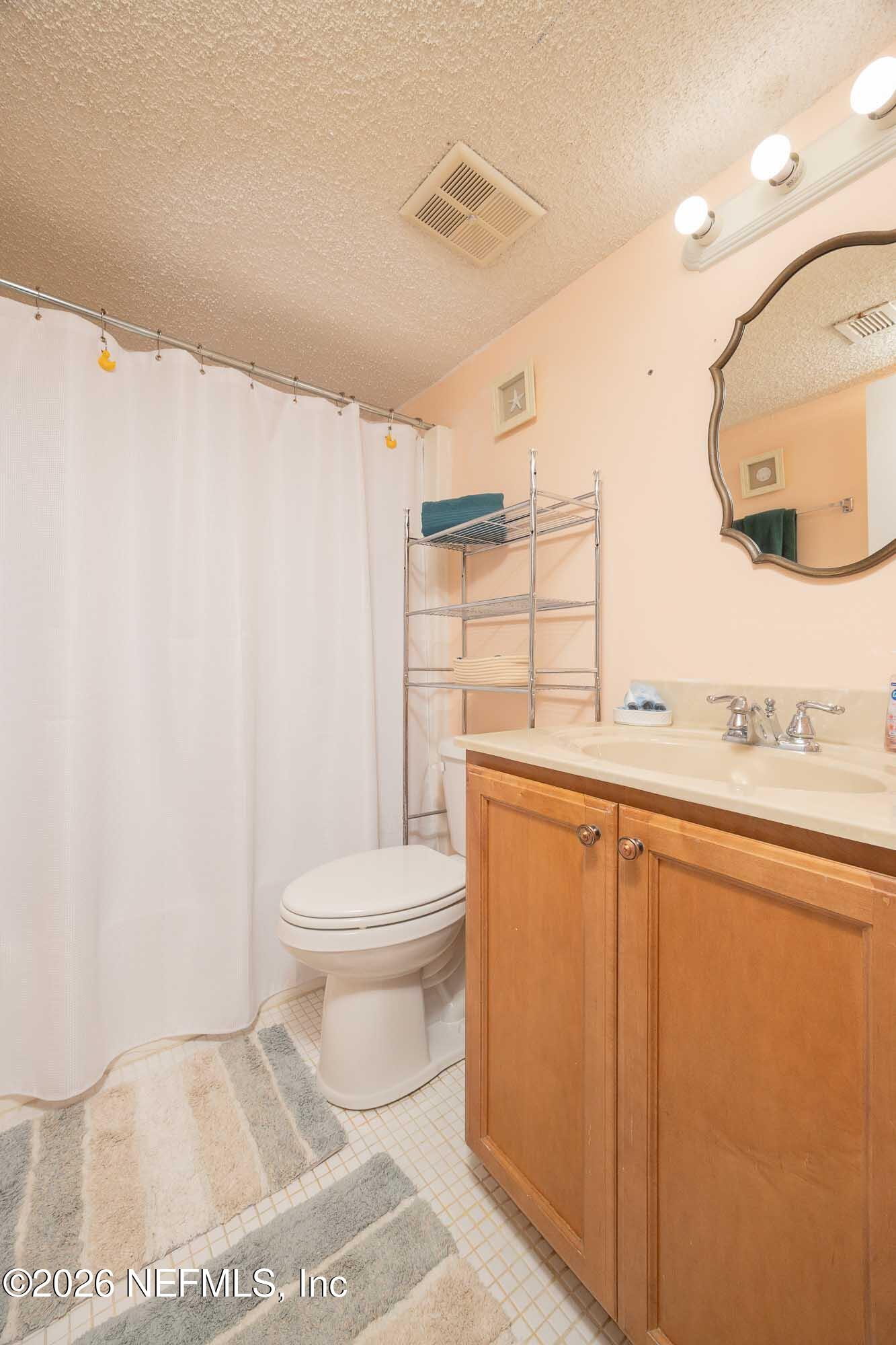 4 Ocean Trace Road, Unit 122 St. Augustine Beach, FL 32080 - Photo 45 of 48 a bathroom with a toilet a sink and a shower