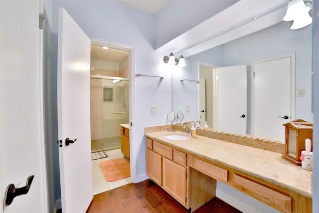 a spacious bathroom with a granite countertop sink and a mirror