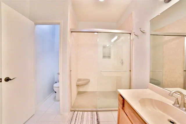 a bathroom with a sink a toilet and a shower