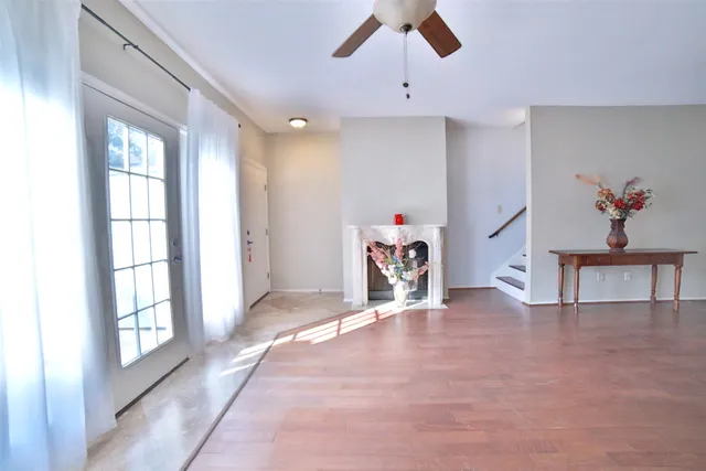 a view of a livingroom with an empty space and a window
