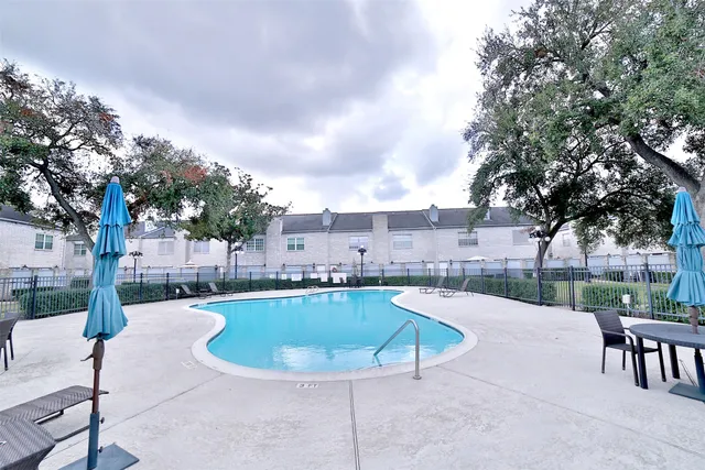 a swimming pool with outdoor seating and yard