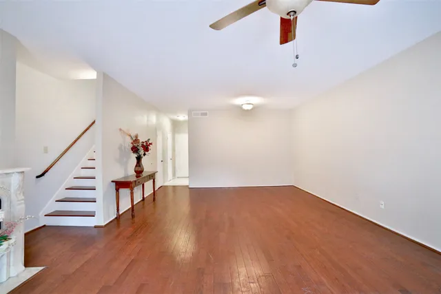 wooden floor in an empty room with stairs