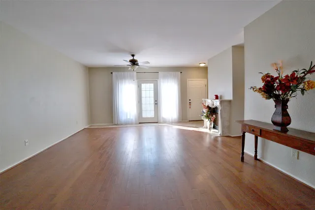 a view of an empty room and wooden floor