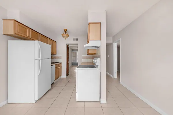 a kitchen with stainless steel appliances a refrigerator and a stove
