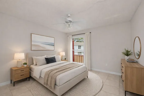 a bedroom with a bed and a lamp on the dresser