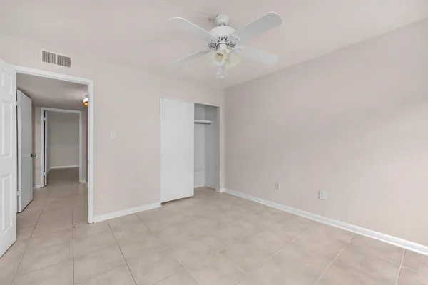an empty room with a ceiling fan and a ceiling fan