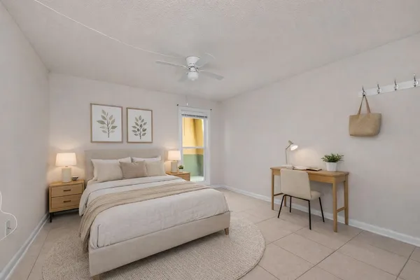 a bedroom with a bed a table and chair