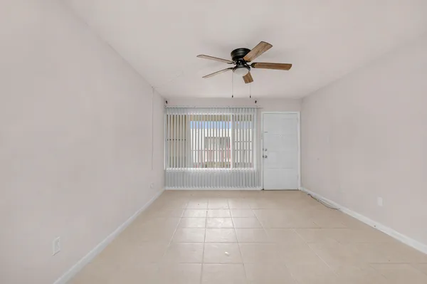 a view of room window and a ceiling fan