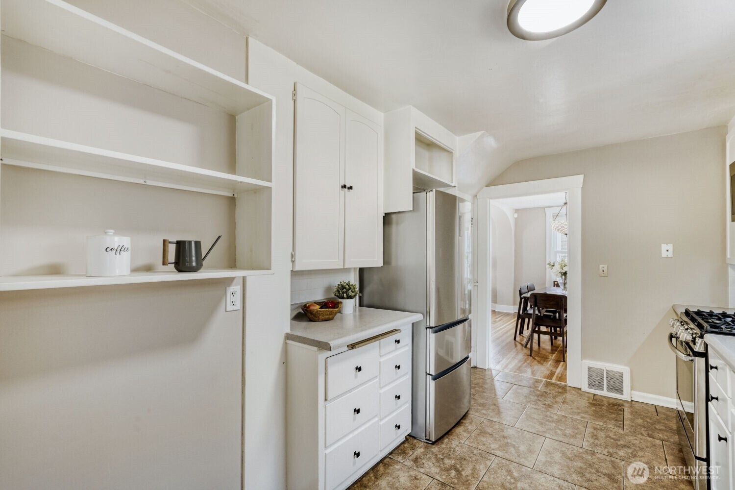 348 Northeast 57th Street Seattle, WA 98105 - Photo 11 of 28 a kitchen with stainless steel appliances a refrigerator sink and cabinets