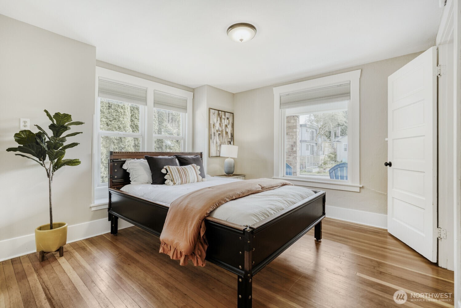 348 Northeast 57th Street Seattle, WA 98105 - Photo 18 of 28 a bedroom with a bed and wooden floor