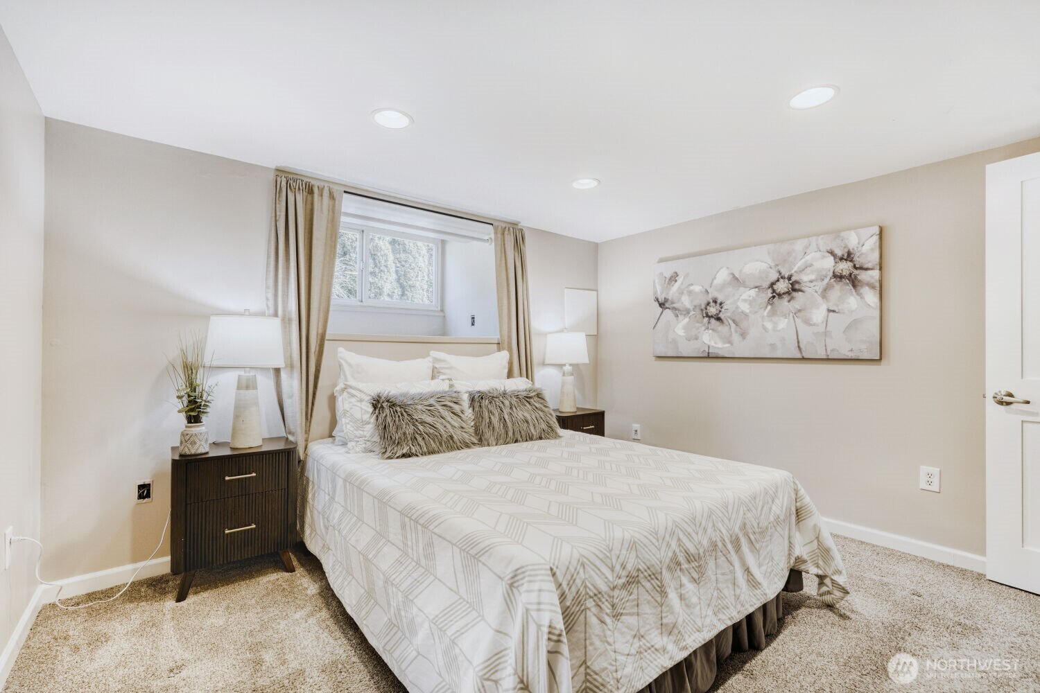 348 Northeast 57th Street Seattle, WA 98105 - Photo 19 of 28 a bedroom with a bed and a painting on the wall