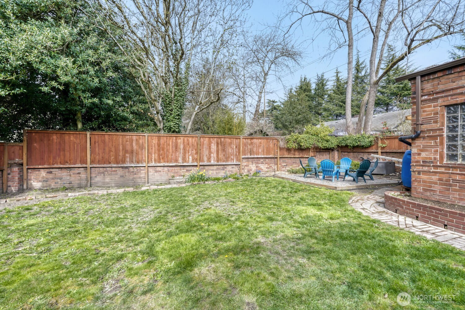 348 Northeast 57th Street Seattle, WA 98105 - Photo 26 of 28 a view of backyard with large trees and wooden fence
