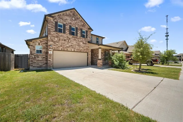 a front view of a house with a yard and garage