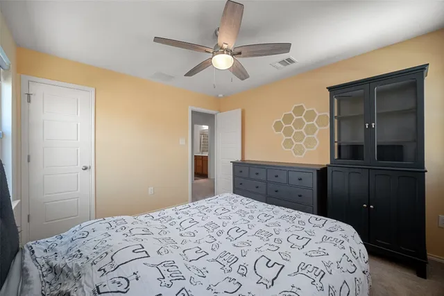 a bedroom with a bed and a dresser