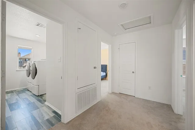a view of hallway with wooden floor
