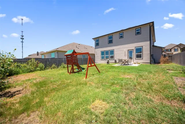 a view of a house with a backyard porch and sitting area