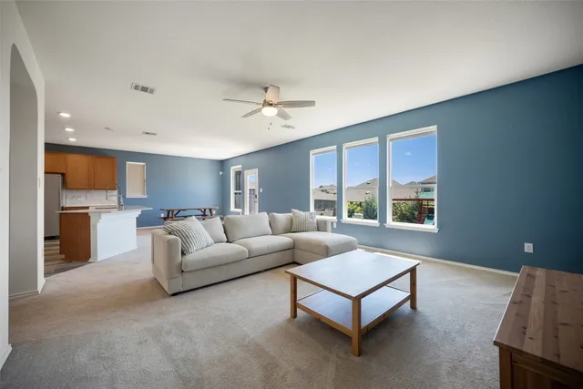 a living room with furniture and a chandelier