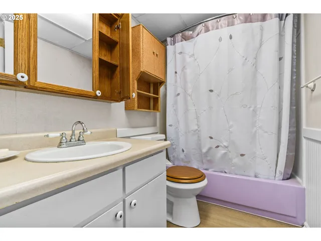 a room with pool table and windows