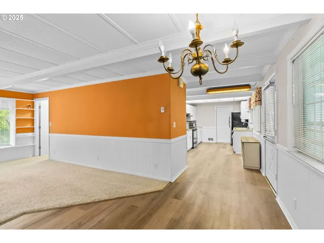 a hallway with white walls and stairs