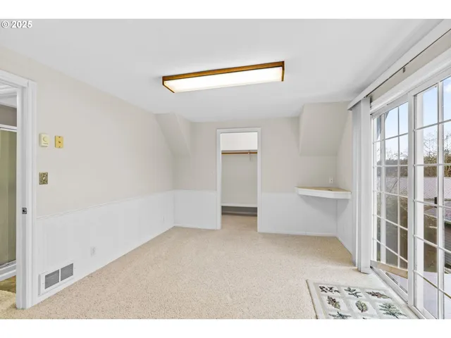 a view of an empty room and a window