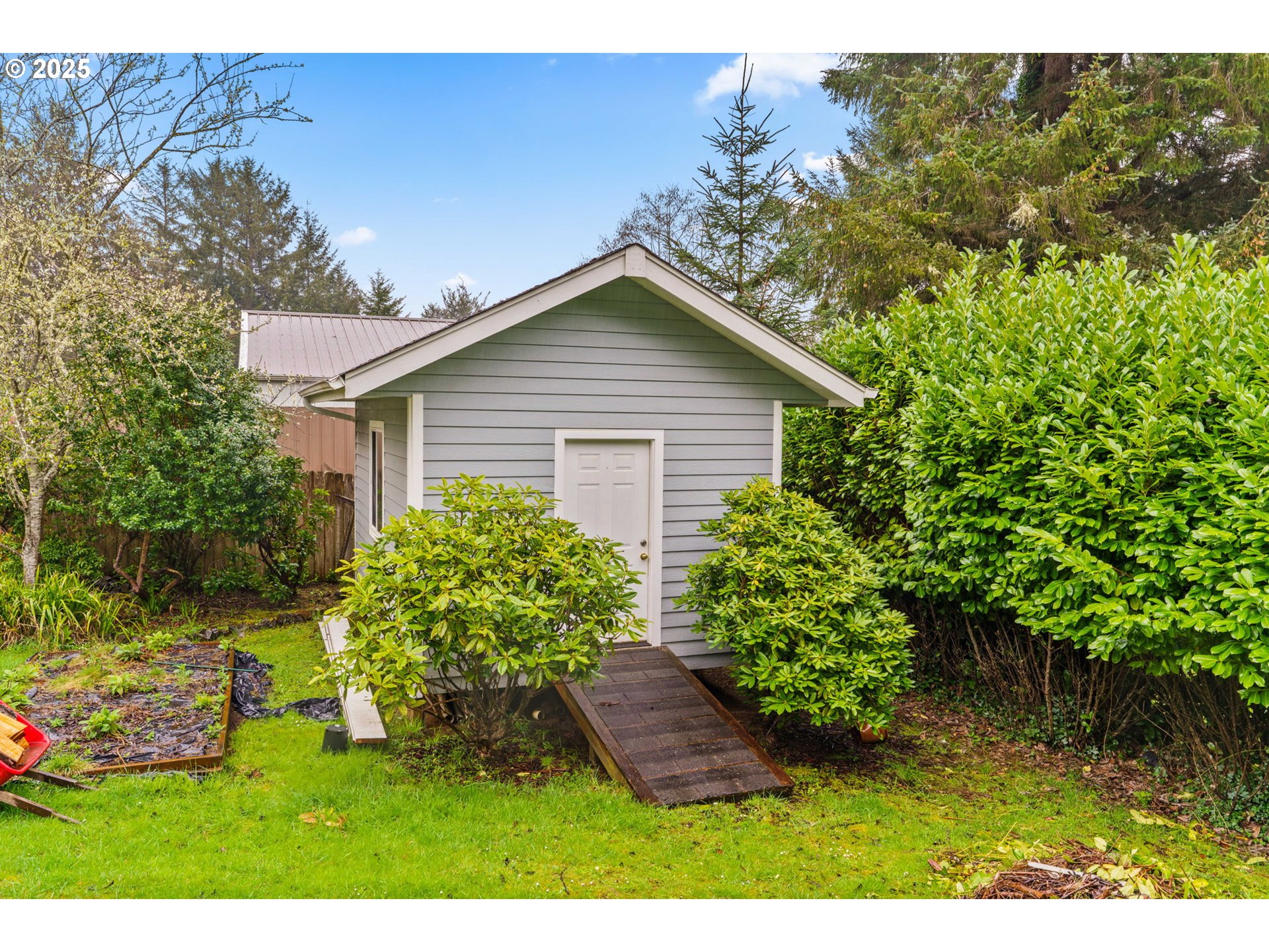 5213 Hilltop Drive Florence, OR 97439 - Photo 31 of 32 a view of a house with a yard and garden