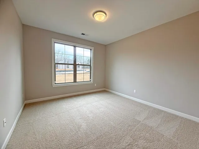 a view of an empty room with glass door
