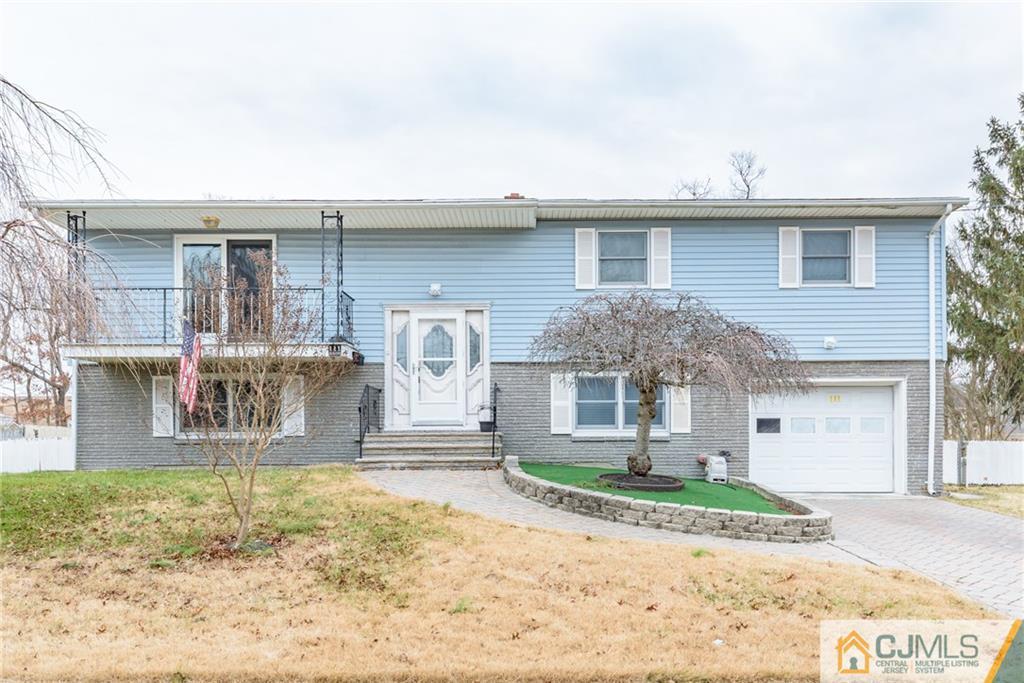 111 Greymoor Road Howell, NJ 07731 - Photo 1 of 25 a front view of a house with garden