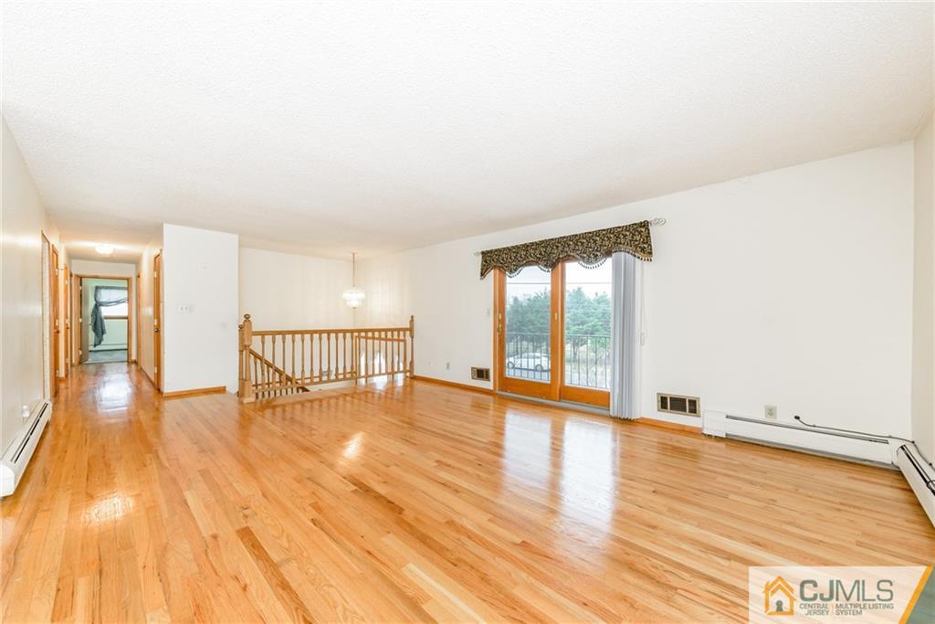 111 Greymoor Road Howell, NJ 07731 - Photo 2 of 25 a view of an empty room with wooden floor and a window