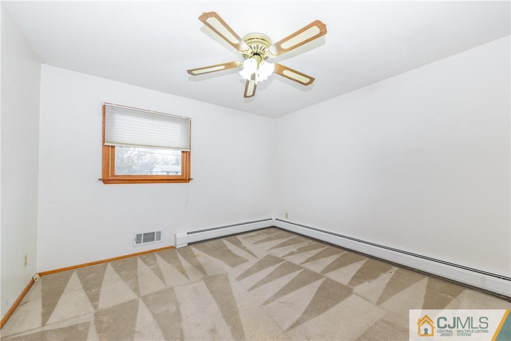 111 Greymoor Road Howell, NJ 07731 - Photo 13 of 25 an empty room with a window and a ceiling fan
