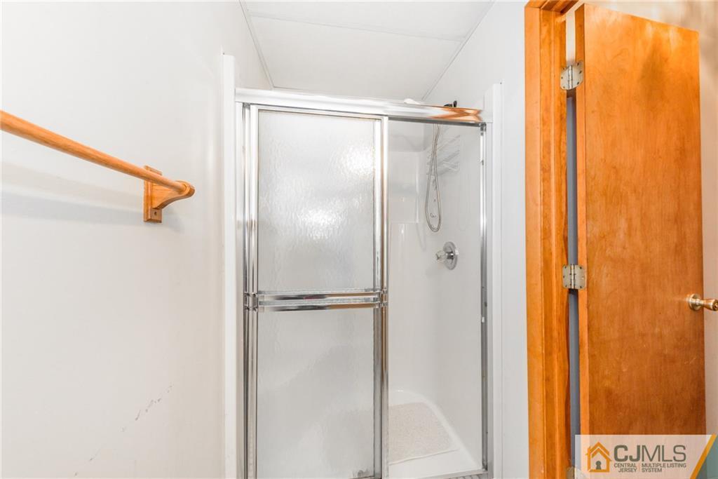 111 Greymoor Road Howell, NJ 07731 - Photo 20 of 25 a bathroom with a shower and a door
