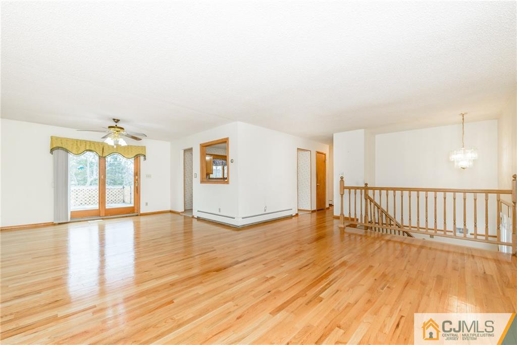 111 Greymoor Road Howell, NJ 07731 - Photo 3 of 25 a view of an empty room with wooden floor and a window