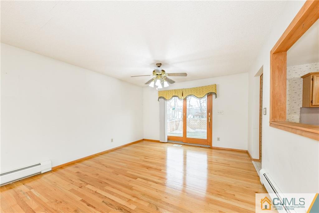 111 Greymoor Road Howell, NJ 07731 - Photo 4 of 25 a view of empty room with wooden floor and fan
