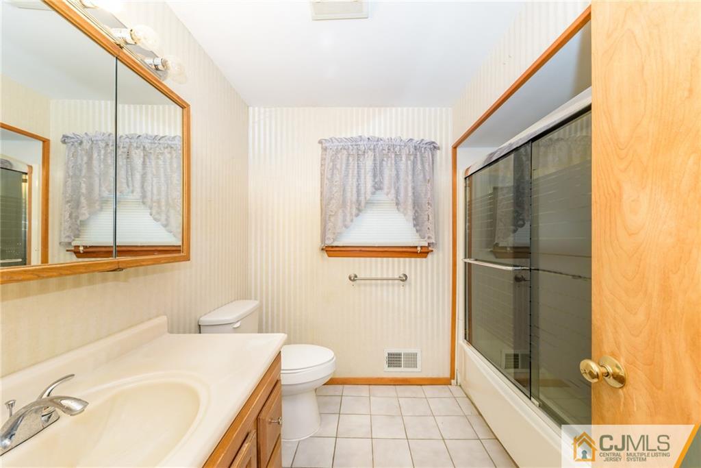 111 Greymoor Road Howell, NJ 07731 - Photo 8 of 25 a bathroom with a sink toilet and shower